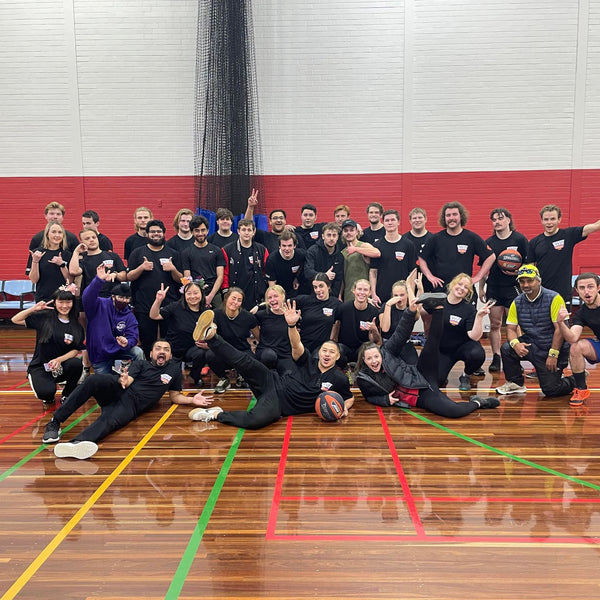 Students posing for a group photo on court