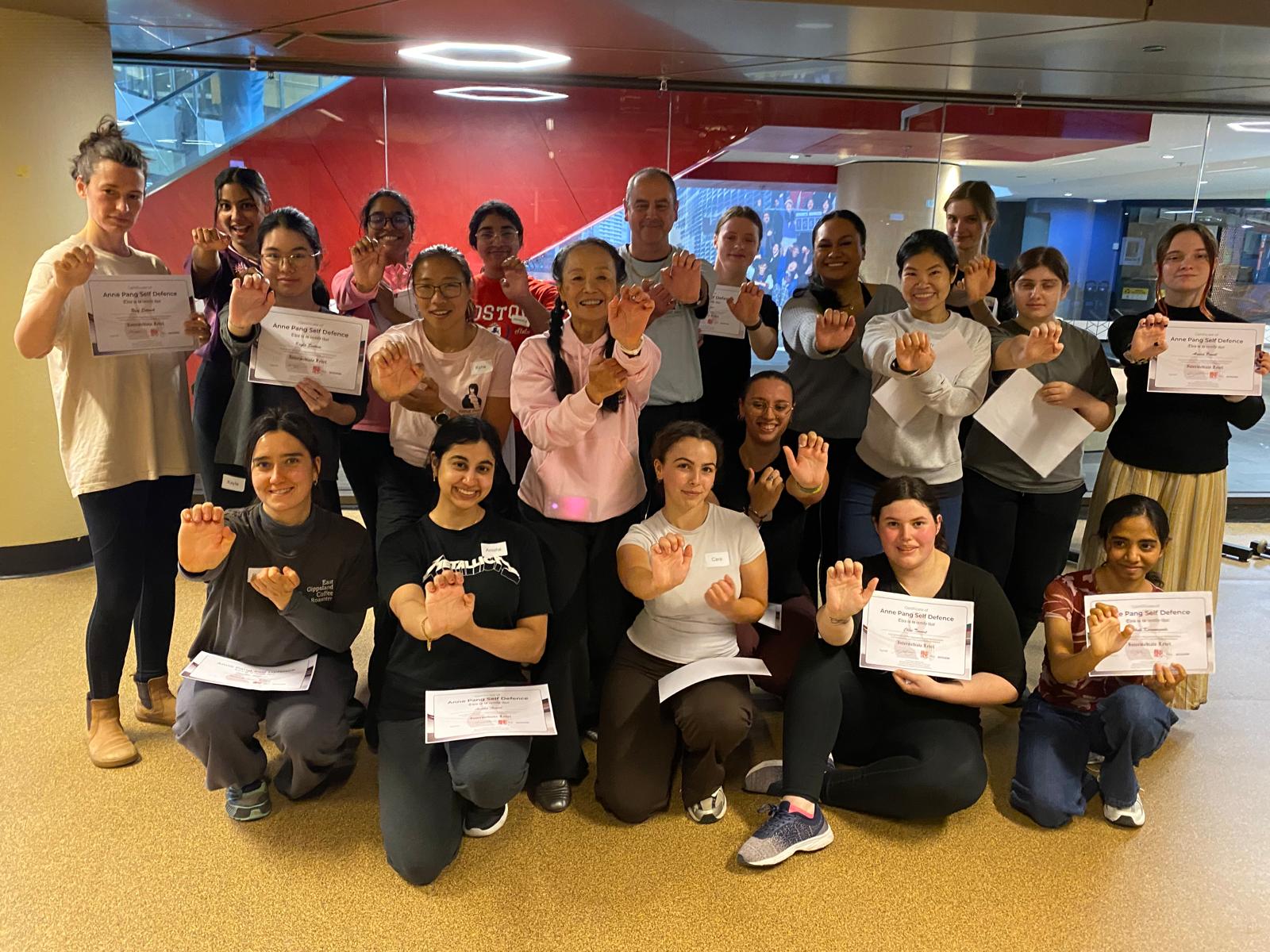 RMIT students and instructors posing with their self-defence certificates
