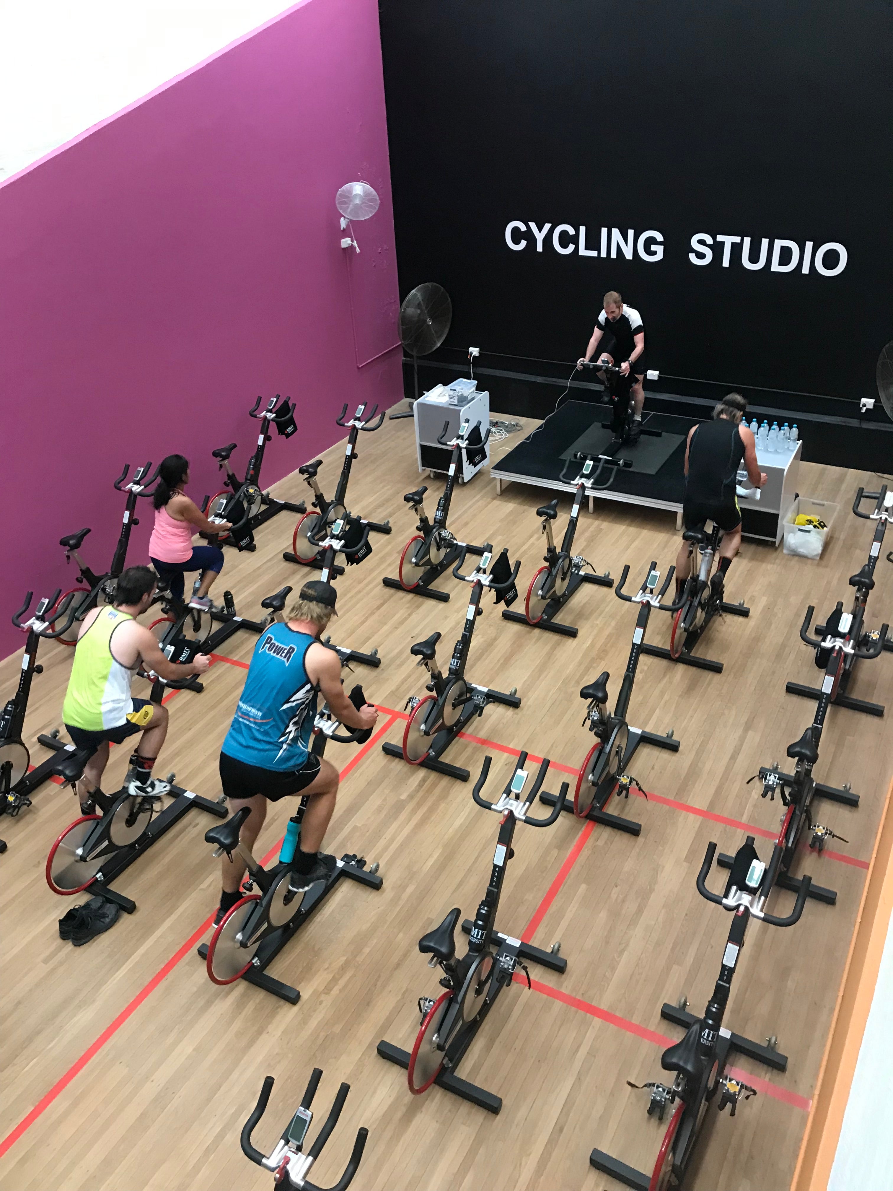 cycle instructor taking a group of participants through a class