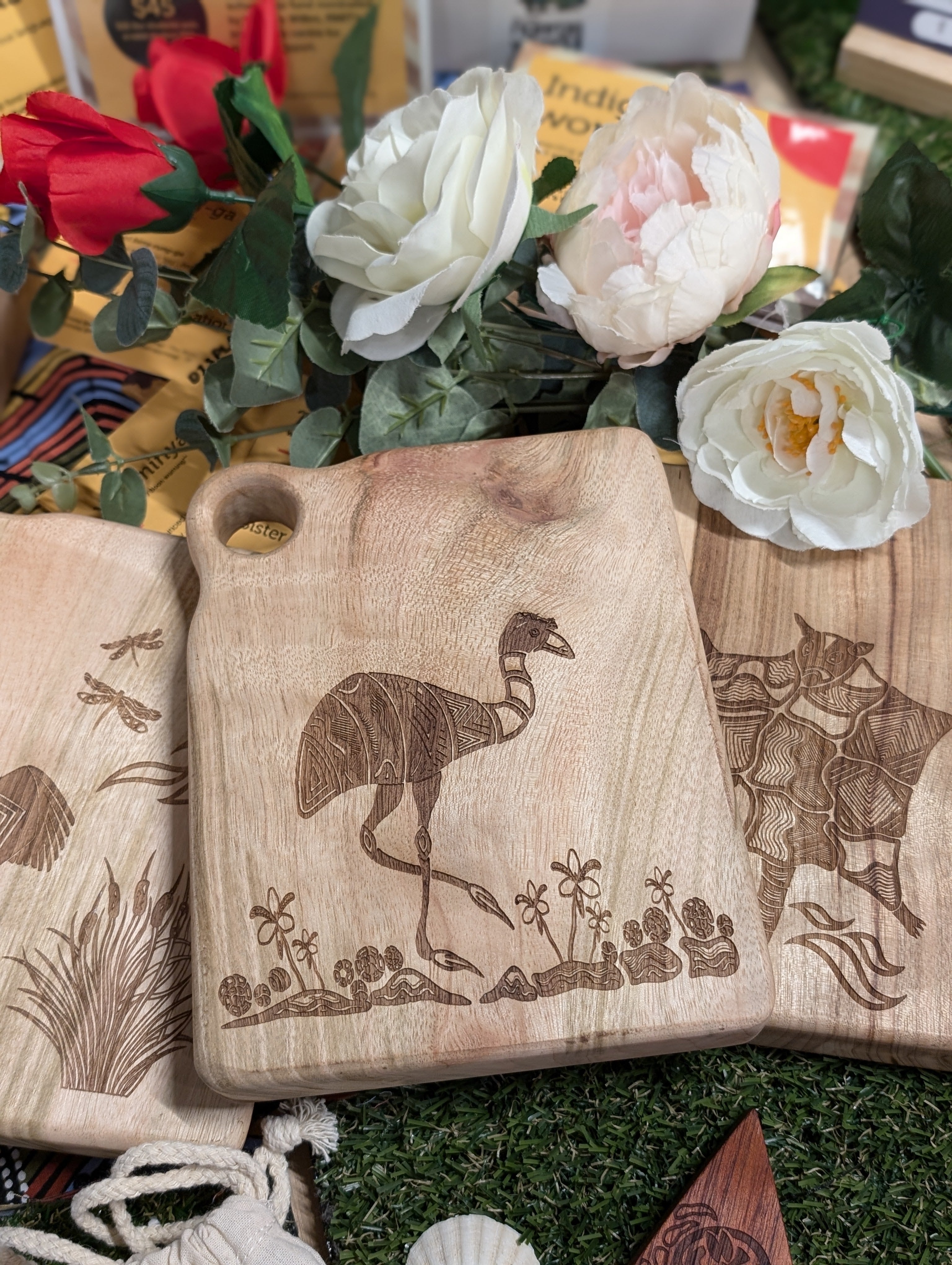 RMIT Store Camphor Laurel Board Extra Mini Rectangle showcasing a detailed engraving of Barramul the Emu amid native flora, highlighting the natural grain of the wood.