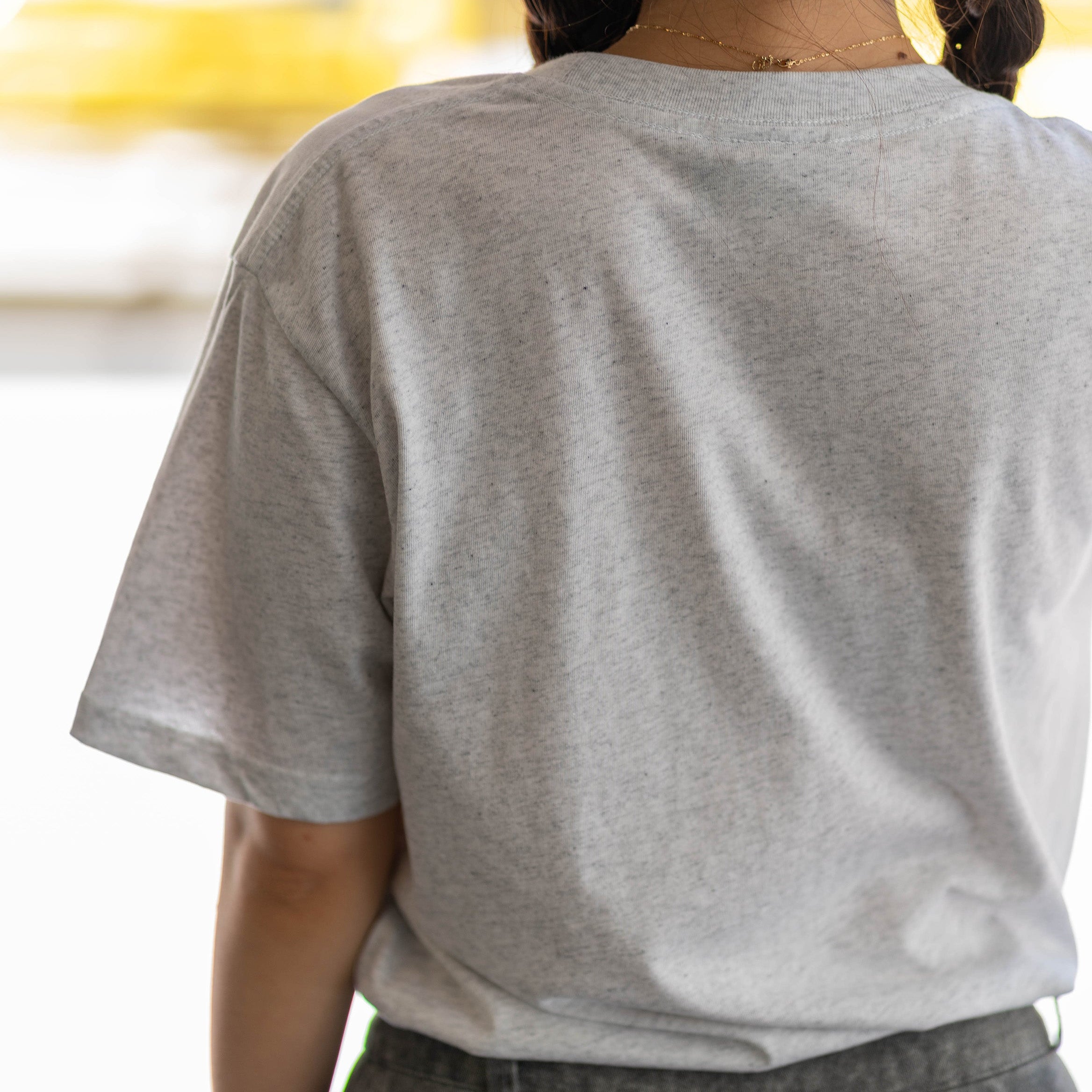 Reverse view of the RMIT Essential Tee in white marle, demonstrating the plain design of the back.