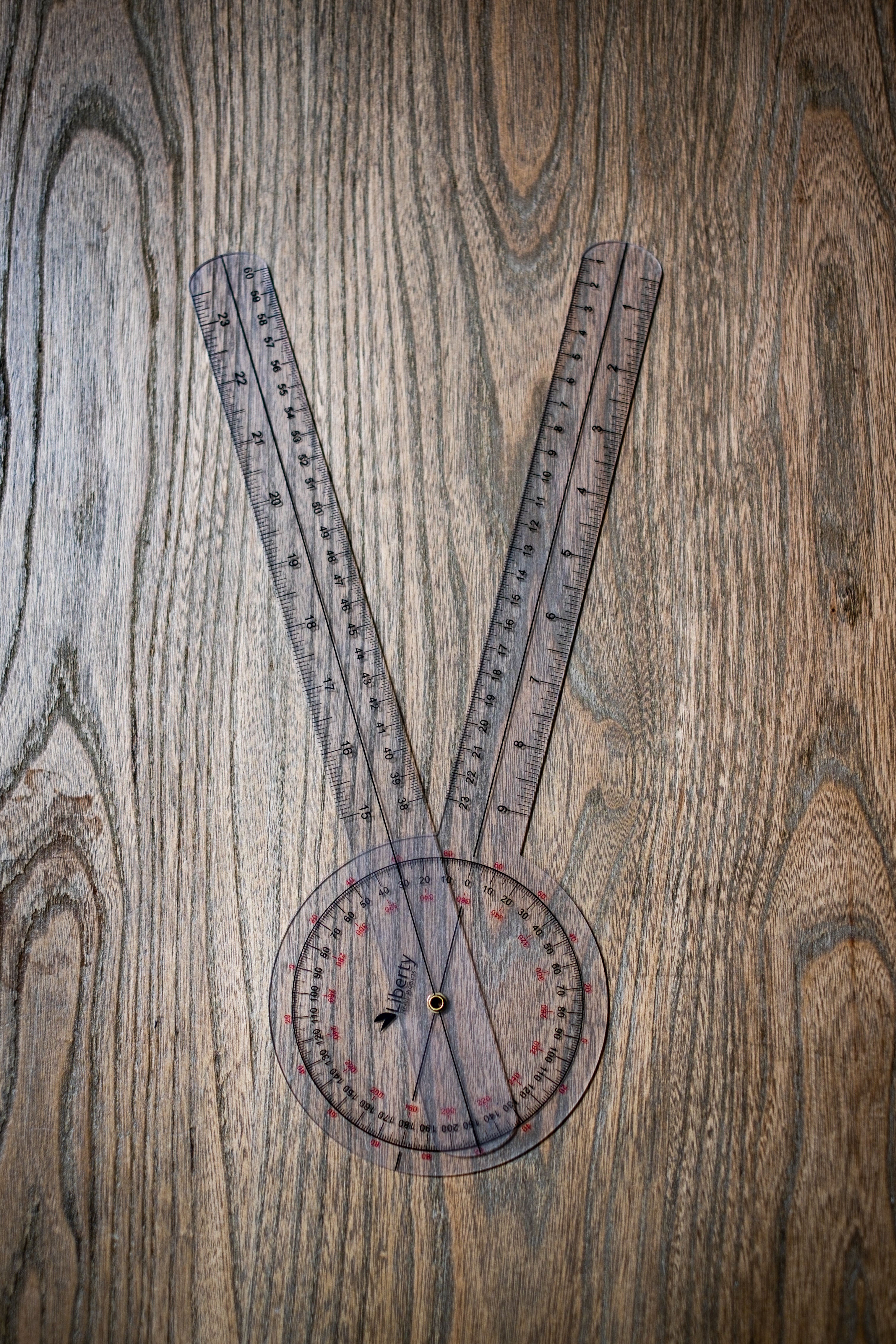 RMIT Store Gniometer, shown in close-up on a neutral background. The device features a clear, transparent body with distinct, marked increments on the scale. The scale is visible along the side, with measurement markers in bold text. The gniometer is typically used for precise angle measurements, with a sturdy, easy-to-handle design that is perfect for both professional and educational settings.