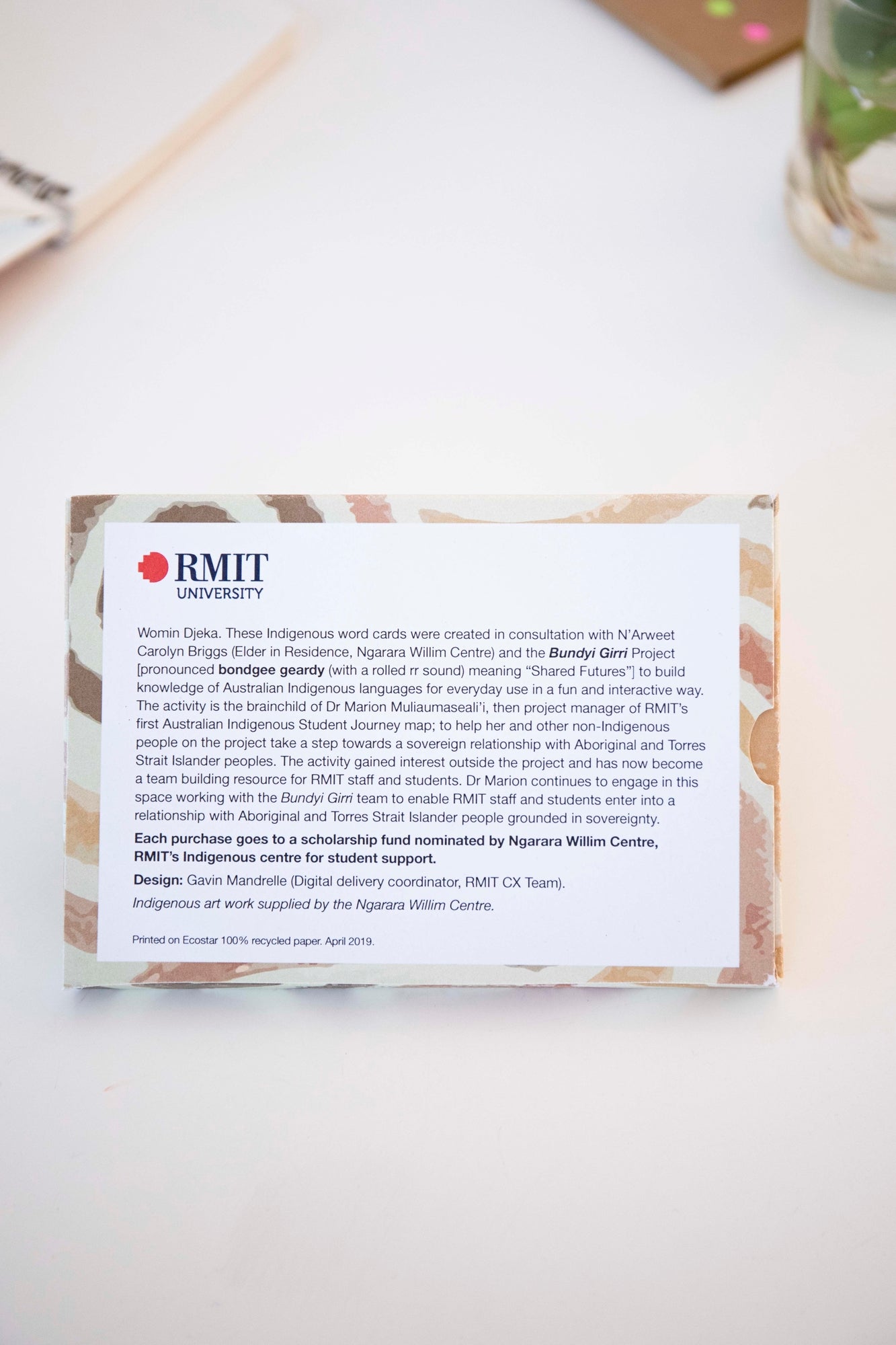 Back view of the Indigenous Words Cards pack from the RMIT Store, showing printed details about the cards and their meanings. The text explains that each purchase supports a scholarship fund nominated by the Ngarga William Centre.
