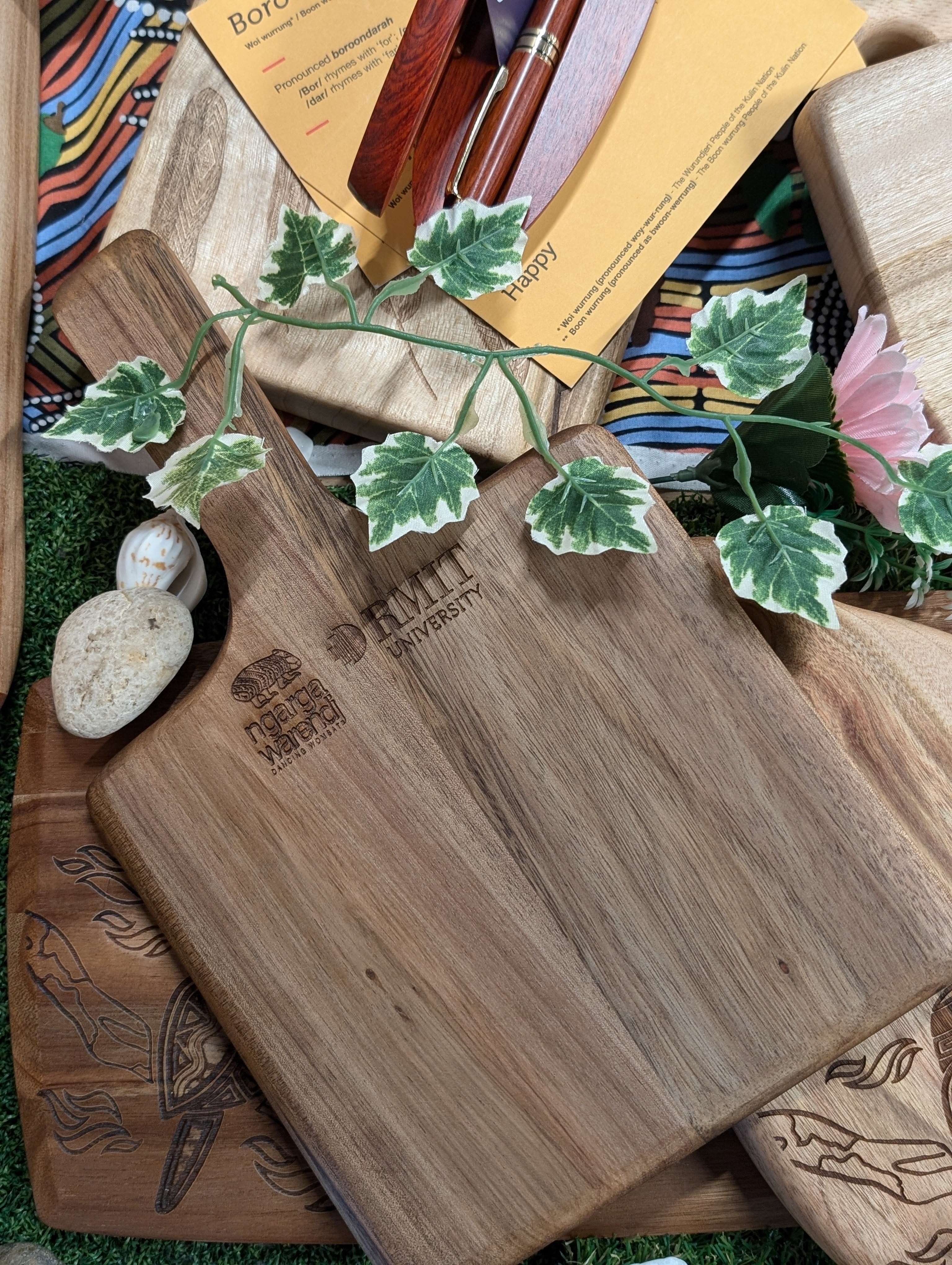 Ngarga Warendj Indigenous Australian designed Bare Bin Buk the Long Necked Turtle engraved Acacia Square Paddle Board with RMIT Branding.  Rear engraved Ngarga Warendj logo and RMIT University log shown from top down view.
