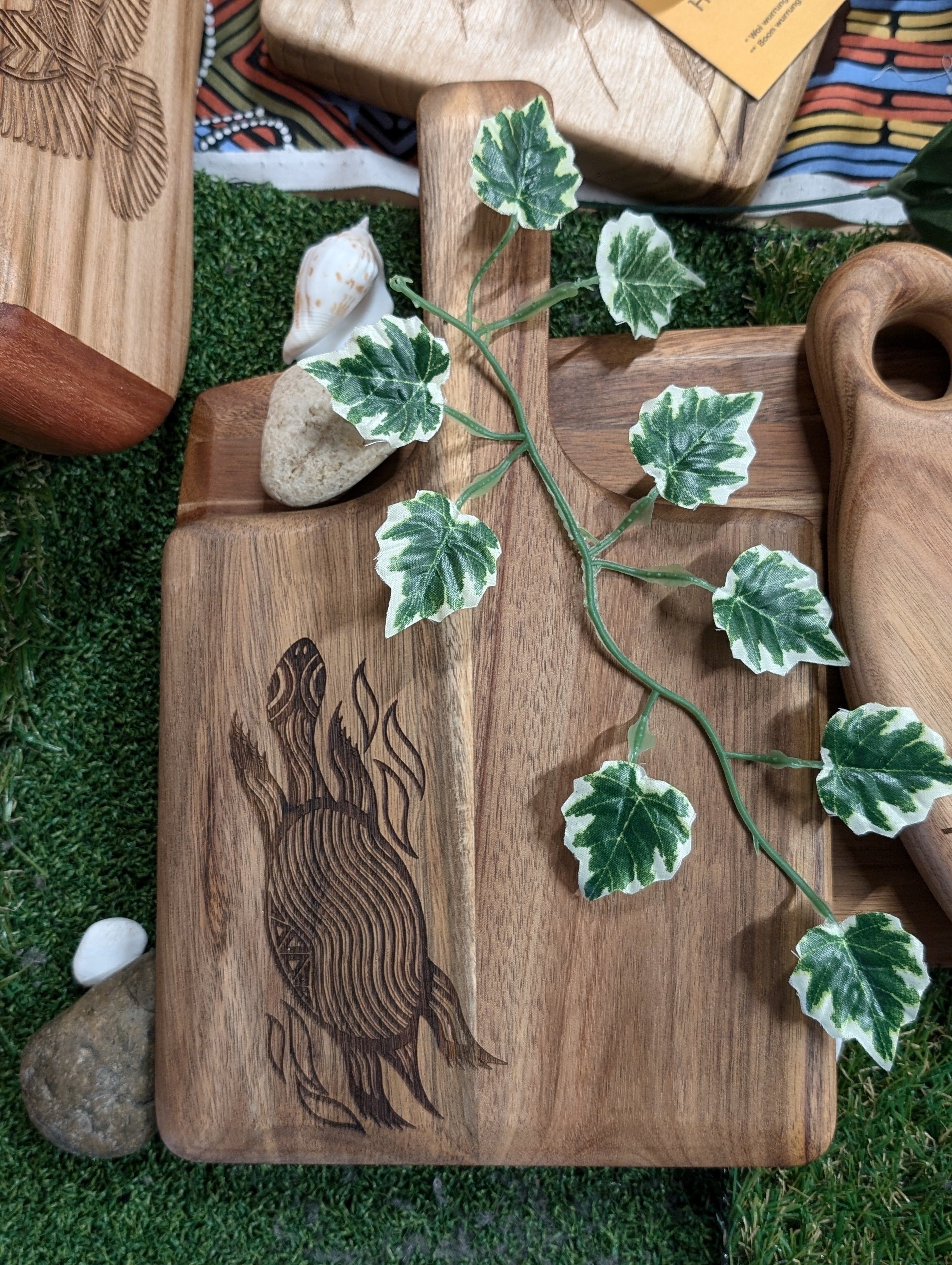 Ngarga Warendj Indigenous Australian designed Bare Bin Buk the Long Necked Turtle engraved Acacia Square Paddle Board with RMIT Branding.  Long Necked Turtle engraved design shown from top down view.