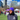 RUSU Beanie in purple with white RUSU embroidered logo modelled by male student outside on the green grass at RMIT University in the Melbourne CBD.