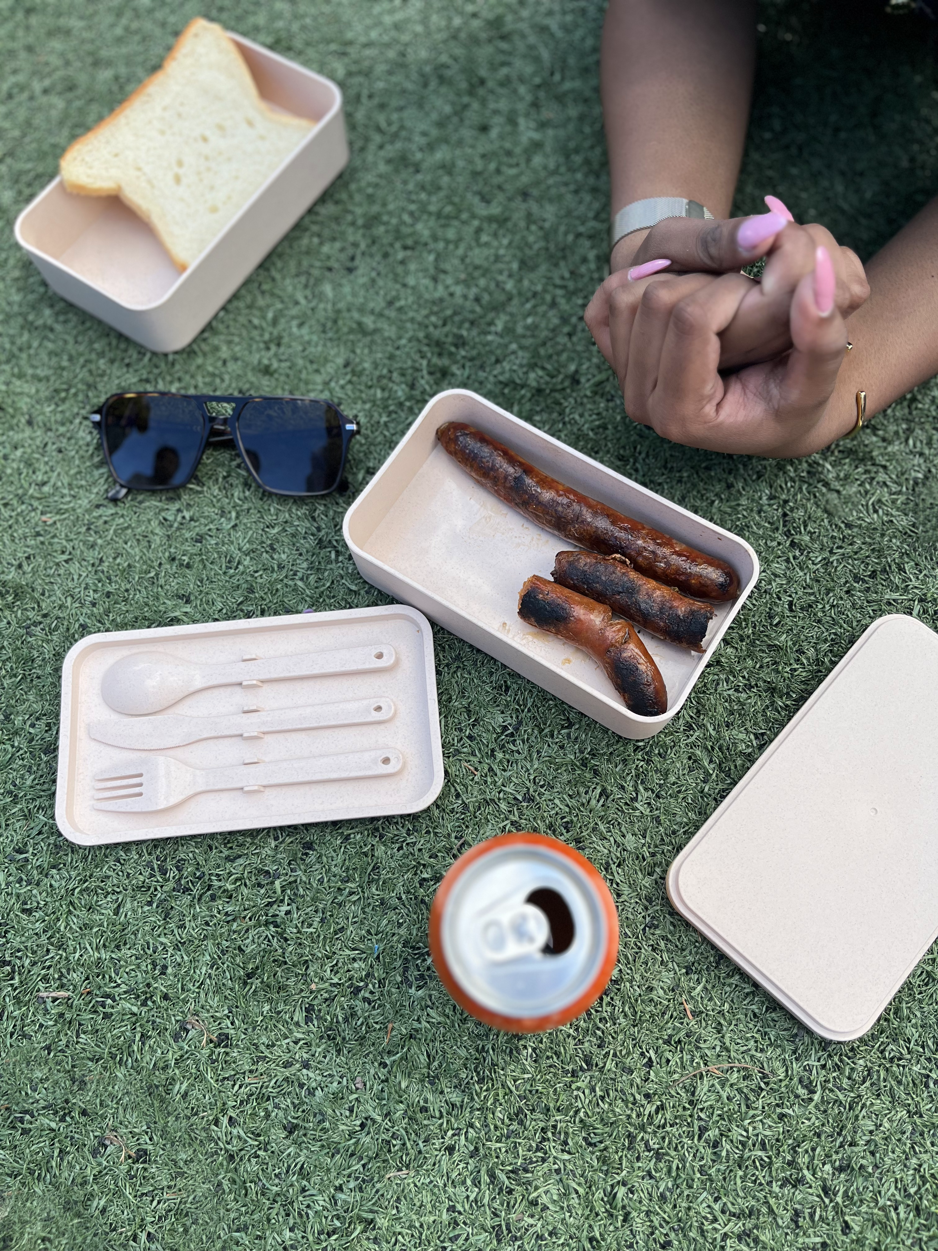 RUSU Lunchbox with two tier storage and logo printed lid with smartphone holder. Modelled in use by student with food and a fully opened unpacked lunchbox.