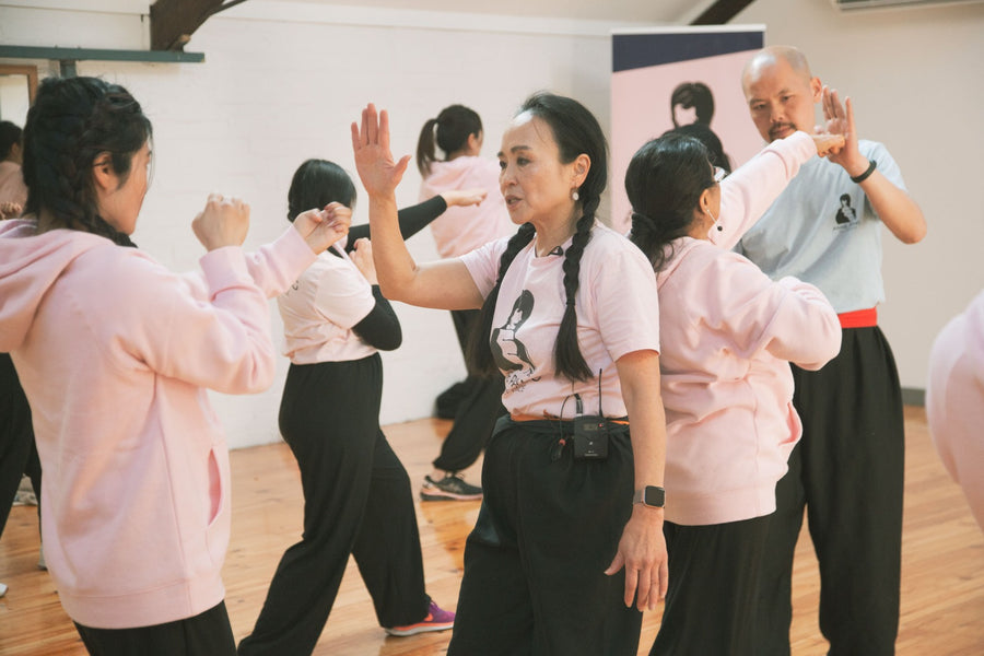 Group of people participating in a martial arts or exercise class indoors at RMIT University.