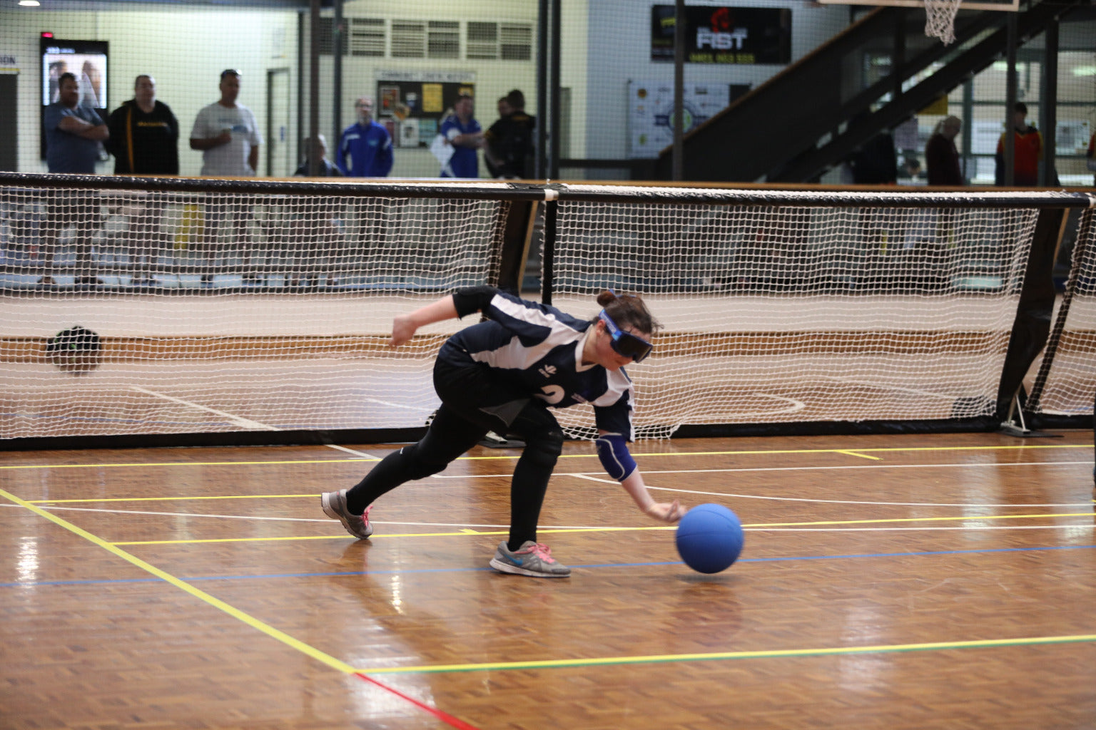 goalball competitor rolling a ball during a match