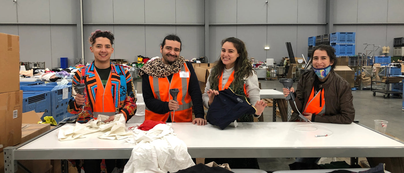Redcross Australia volunteers helping sort and pack clothing