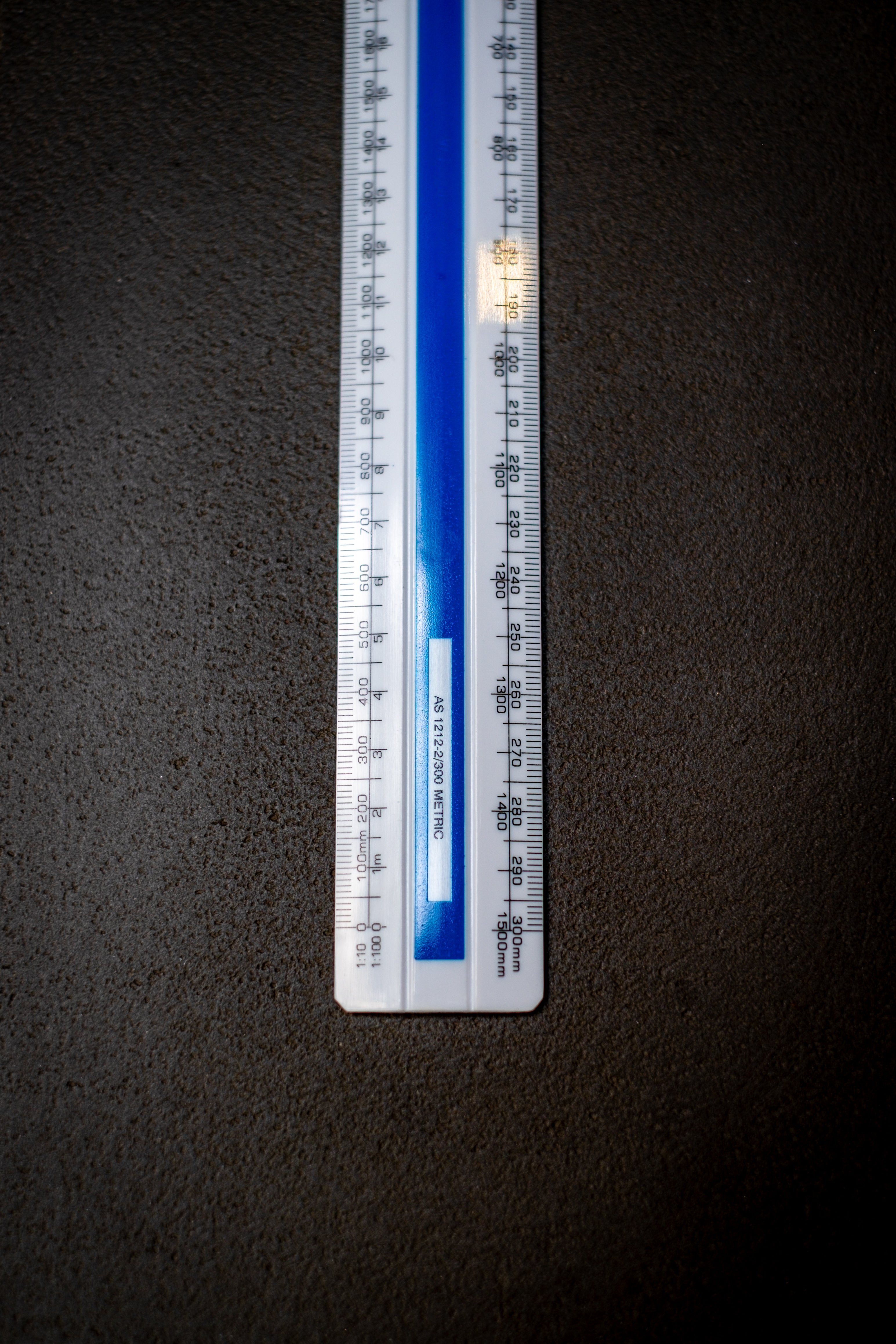 Close-up of the lower portion of the Scale Ruler M62 from the RMIT Store, featuring accurate metric scale markings on a textured background.