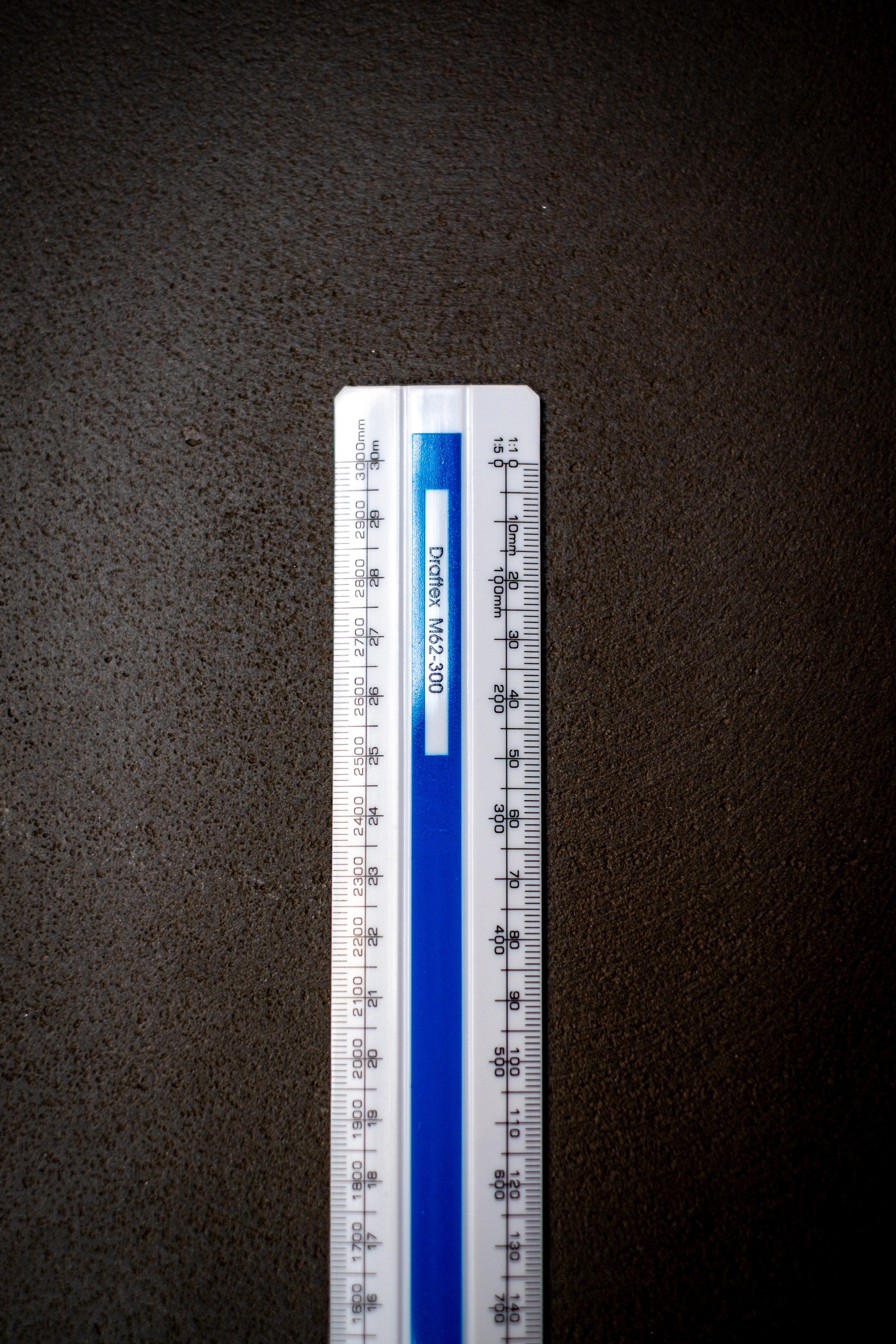 Detail shot of the upper section of the Scale Ruler M62 from the RMIT Store, presenting metric measurements clearly against a dark surface.